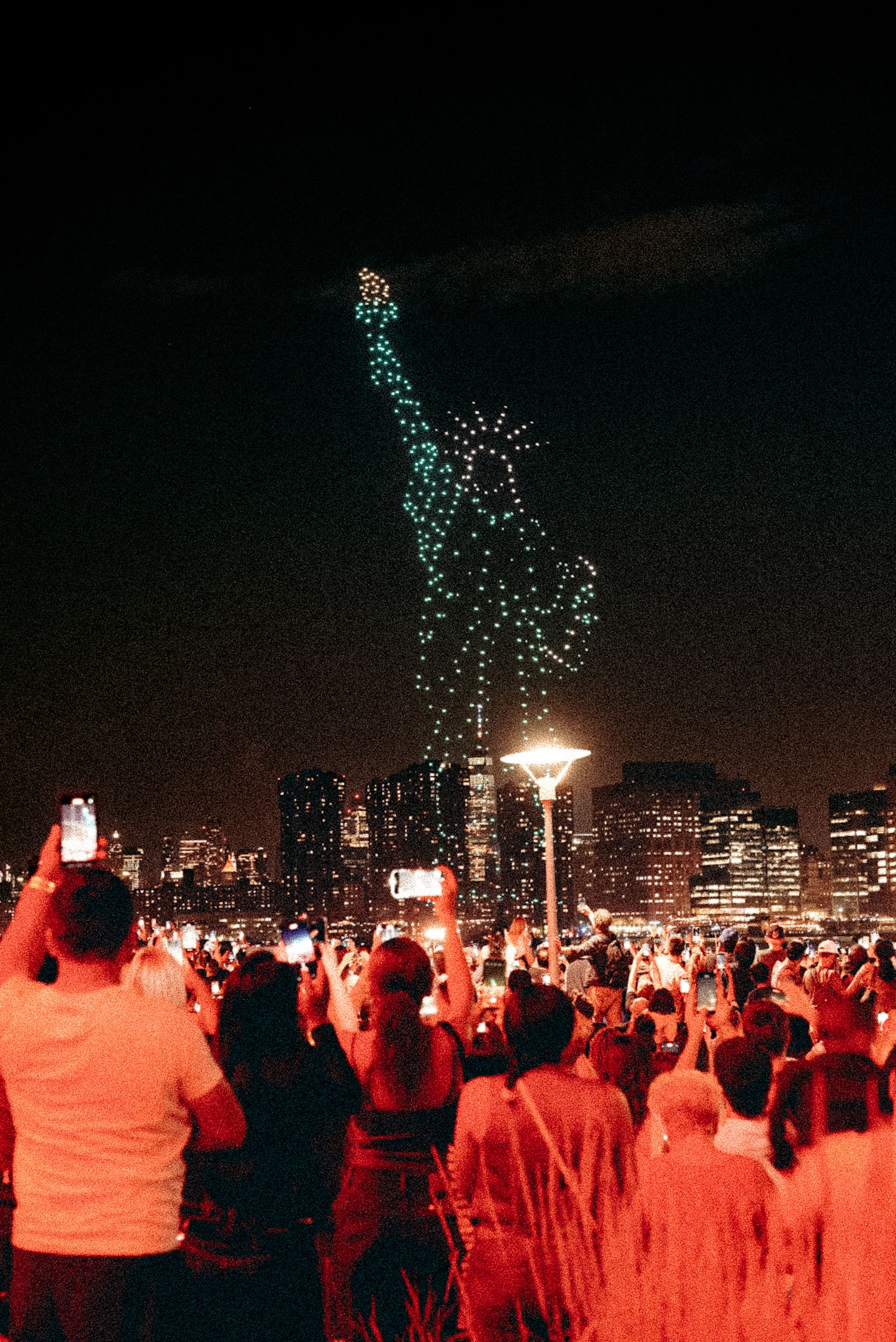 Stand-in photograph of a drone light show over a crowd. Not an Aerial Swarm performance.